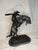 A dramatic and iconic rendering of Frederic Remington’s celebrated Western masterpiece, “The Bronco Buster.” This...