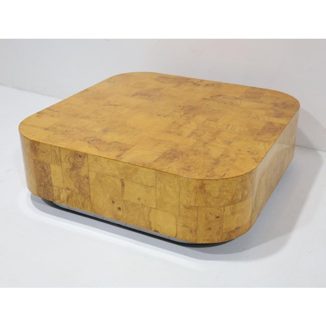 A substantial cocktail table designed by Paul Evans. Table is a patchwork burlwood resting on a brushed chrome platform...