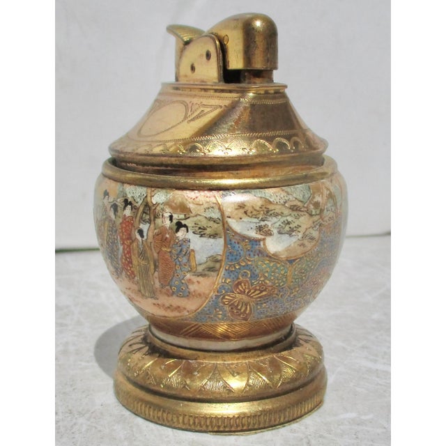 Vintage Satsuma table lighter. Wonderful scene wraps around the lighter with gilt mounts on the base and on the lighter....