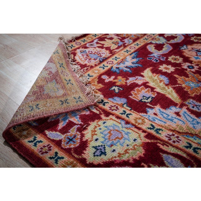A hand-knotted wool Oushak, made in India and measuring 8' x 10'. Oushak weaving is known for large-scale, softly drawn...