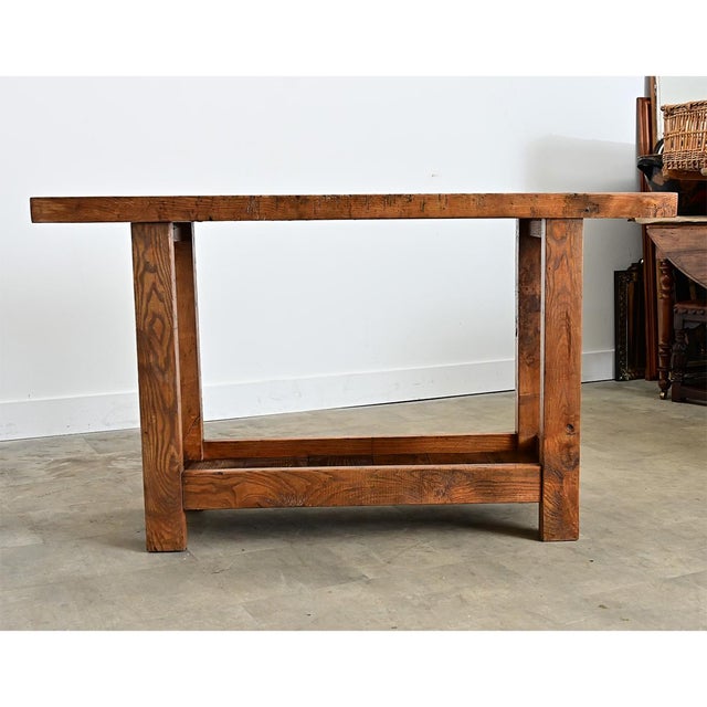 A French oak workbench from the 19th Century feels sturdy in its squared-off design yet light in its openness. The top is...