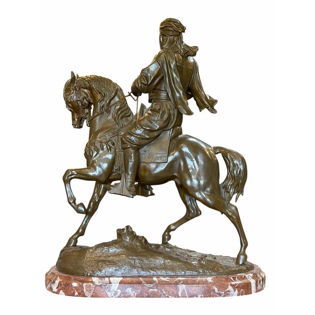 A finely cast bronze equestrian sculpture by French artist Alfred Barye, depicting a mounted cavalier in dynamic motion....