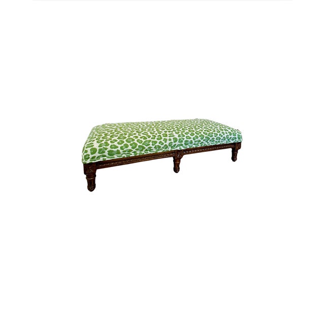 Antique footstool featuring a beautifully hand-carved wooden base with turned legs and decorative apron detailing....