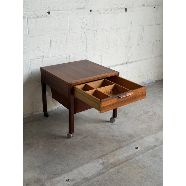 This exceptional multi-functional mobile workstation presents a square top elevated on clean square legs. An organized...