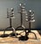 This set of three hand-forged wrought iron candlesticks showcases the rugged artistry of Spanish Revival design. Each...