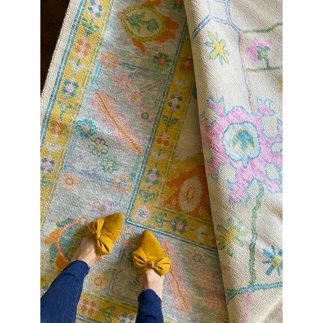 Colorful pink, blue, yellow, green modern handknotted oushak rug As all of our rugs are made by hand, each may have slight...