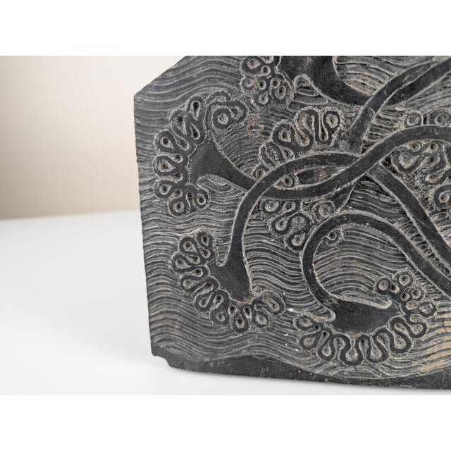 Hand-carved in the 1970s, this slate bas-relief features detailed floral motifs. The stone, with its characteristic...