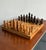 This monumental vintage chess set is a breathtaking celebration of oversized artisanal design and organic texture....