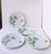 A set of four (4) white porcelain plates (salad plate size) with a linen-like surface and green bamboo design, circa...