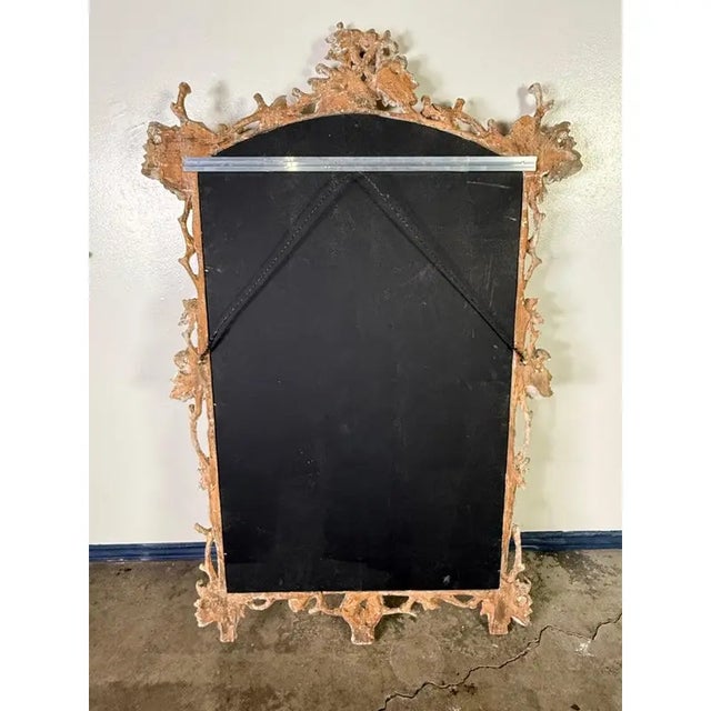 Beautifully ornate carved wood mirror featuring heavily detailed naturalistic frames. Each frame is adorned with twisting...