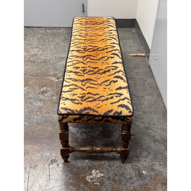 Design Plus Gallery presents an Antique Italian Carved Wood Bench. The bench is upholstered in a Tiger Print palette of...