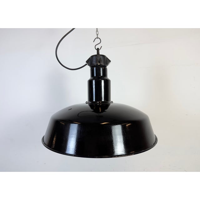 Industrial black enamel pendant light made by elektrosvit in former czechoslovakia during the 1950s. White enamel inside...