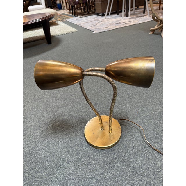 Design Plus Gallery presents a Double Head Gooseneck Brass Table Lamp. This retro, funky table lamp will amp us your mid-...
