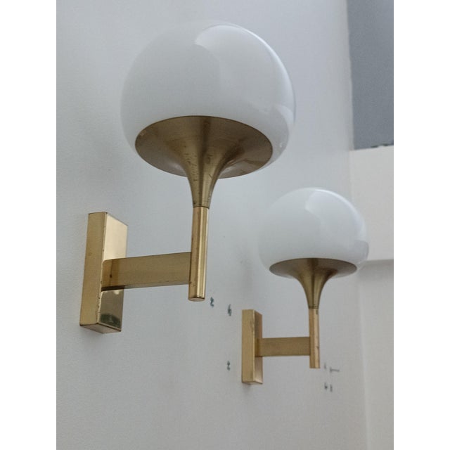 Beautiful pair of wall sconces by Gaetano Sciolari for Maison Sciolari. Italy, 1970s. Brass structure supporting a sublime...