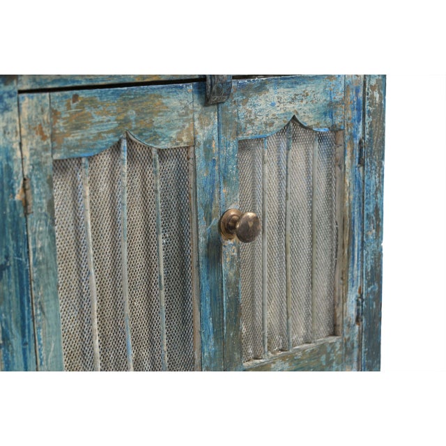 Vintage Indian Painted Small Cabinet, with mesh panel doors and pressed glass sides, originally a food storage cabinet. In...