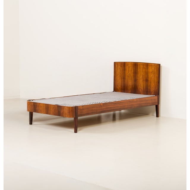 This Danish Pau Ferro rosewood bed frame was made in the 1960s. Crafted from solid Pau Ferro and Pau Ferro veneer, it...