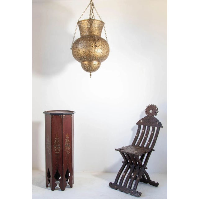 Vintage 1960s Moroccan pedestal table. hand painted Moroccan side table on a dark maroon background color with floral and...