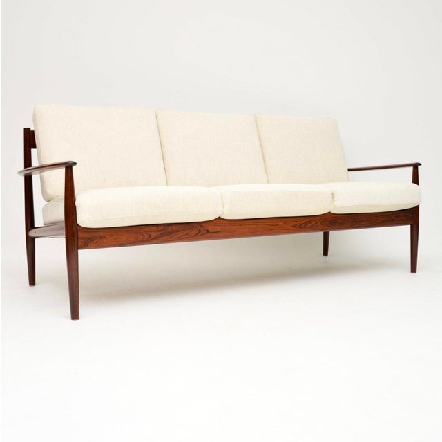 An extremely rare and absolutely stunning pair of vintage Danish sofas by Grete Jalk for France and Son. They were made in...