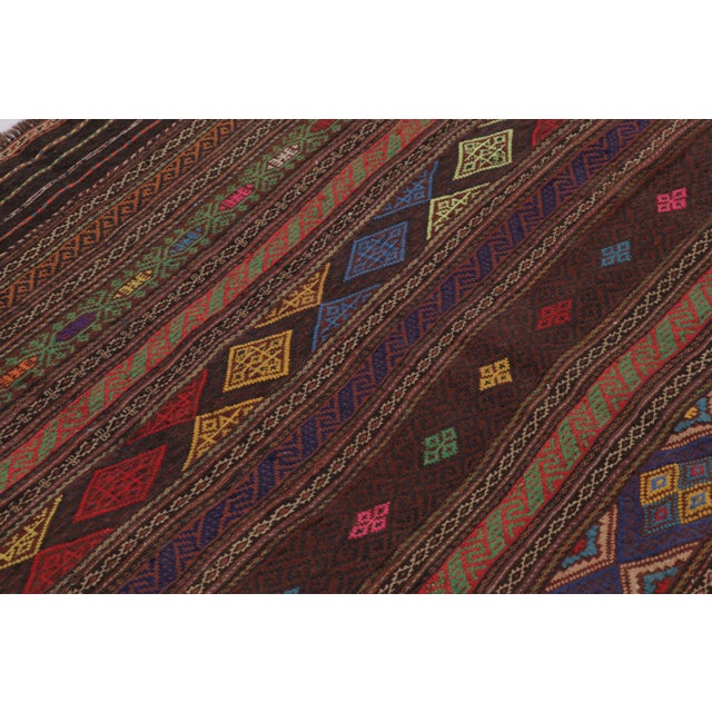 Made with handwoven wool circa 1950-1960, this 4x7 vintage Persian Kilim, originating from the Larkhabi region of...