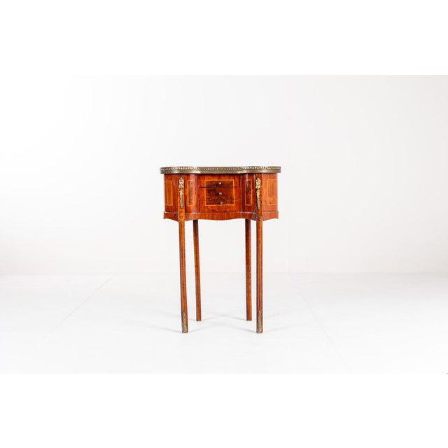 Elegant antique side table in the Louis XV style, dating from the early 20th century. This charming piece features a...