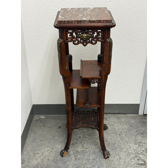Design Plus Gallery presents a Chinoiserie Carved Wood Tiered Stand with Marble Top. This distinctive stand is constructed...
