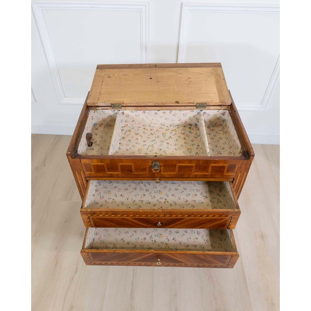 Louis XVI marquetry chiffonniere table from the end of the 18th century. It opens on the front with two drawers and a...