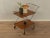 A classic serving cart from the 1960s in Scandinavian design. It features a foldable metal frame with two teak trays,...
