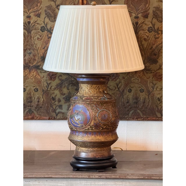 Champleve bronze vase mounted as a table lamp, the baluster body cast in low relief with dense scrollwork and enameled in...