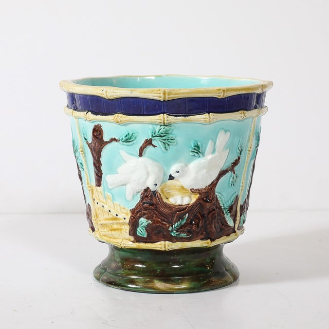 This remarkable pair of signed Majolica ceramic cachepots, crafted in France circa 1890, is a celebration of nature and...