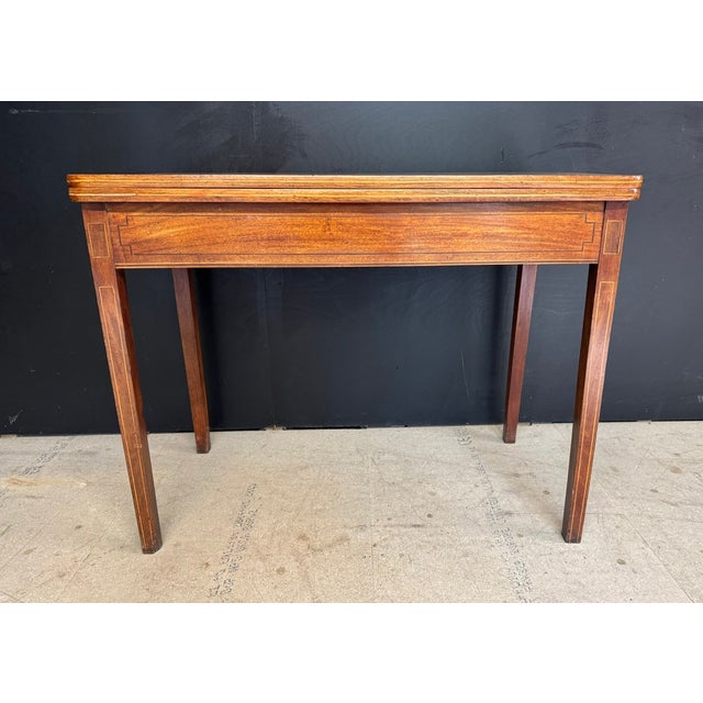A nice quality Georgian Tea Table, made from Mahogany with Box wood inlays. The back leg gates open and the top flips over...