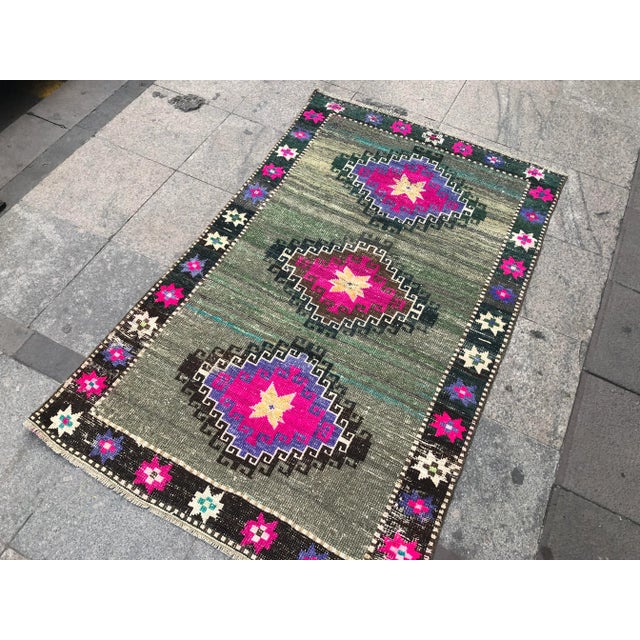 This is a vintage Turkish Oushak rug from the 1960s. The piece was hand-knotted.