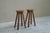 A pair of mid century bar stools in solid oak and wrought iron. Europe, 1960s. These bar stools feature a modest yet very...
