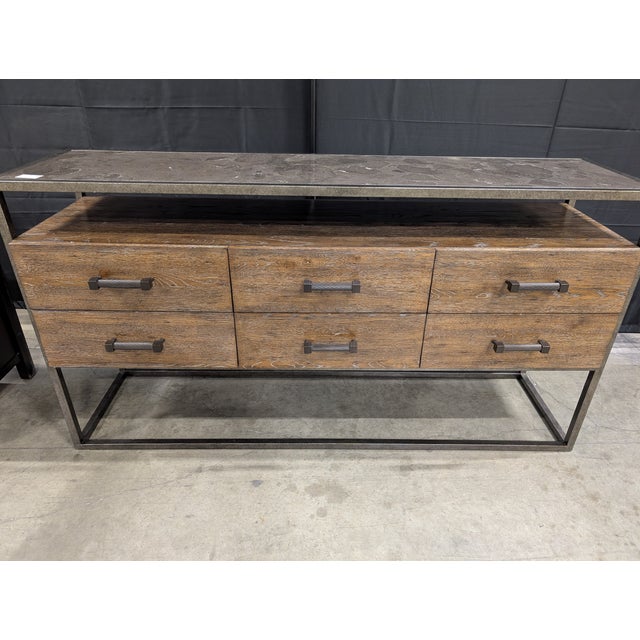 A beautifully crafted console cabinet by Bassett, featuring a warm dark wood finish with visible grain for rich texture...