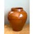 This vase presents a classic, full-bodied silhouette rooted in traditional North African pottery, its rounded shoulder...
