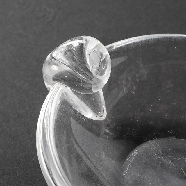 This elegant Mid-Century Modernist crystal dish, crafted circa 1960 and signed by Steuben, perfectly exemplifies the...