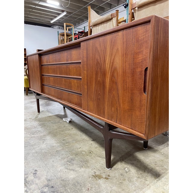 Rare Danish Mid Century Modern teak sideboard by Knud Nielsen for Losning Mobelfabrik.