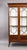 A fine Edwardian mahogany inlaid display cabinet of elegant proportions, featuring three glazed doors with decorative...