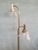 Vintage floor lamp in gilded brass. It features two frosted glass lenses. Excellent overall condition, fully functional....