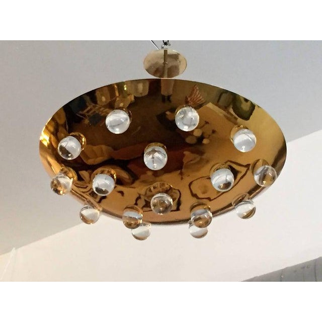 A wonderful pair of 1960s French solid brass round disc fixture with 16 solid glass orbs. Five-light sources which emit...