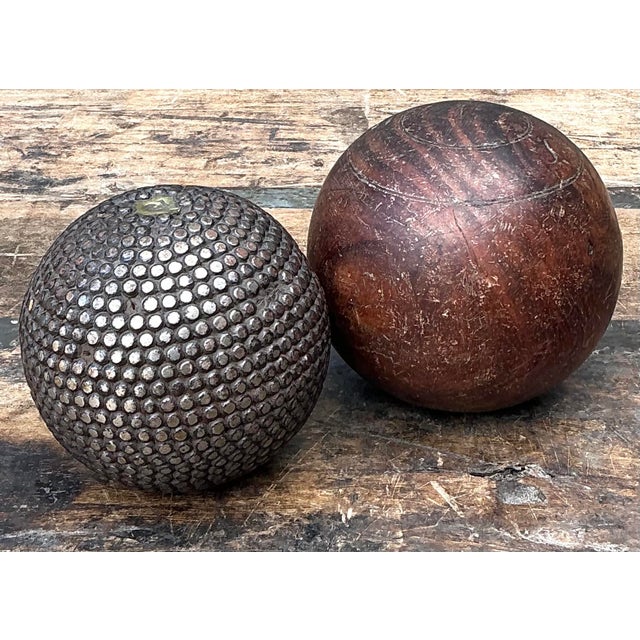 This curated pair of vintage decorative spheres offers a sophisticated study in textural contrast, blending organic warmth...