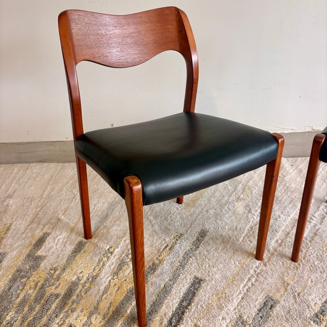 Stunning pair of Niels Møller Model 71 dining chairs in solid teak, just professionally reupholstered in top-grain buttery...