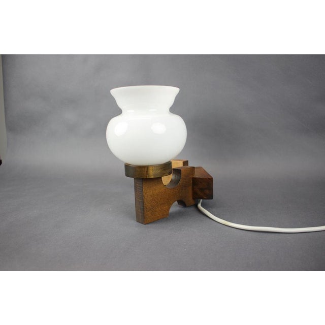 This rare Czechoslovak wall lamp from the 1960s features original marked glass shades produced by Valasské Meziříčí,...