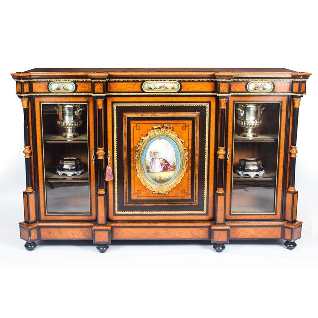 This is a superb antique victorian burr walnut and ebonized sèvres porcelain and ormolu-mounted line inlaid breakfront...