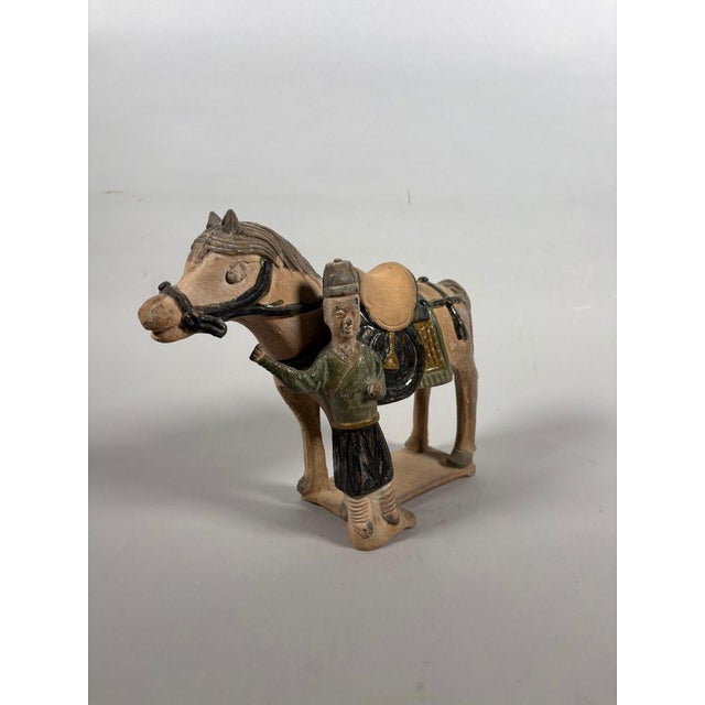Sculpture of a stable boy, China, Ming Dynasty (1368-1644 AD), green-glazed terracotta sculpture. Depicts a standing...