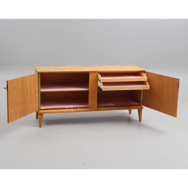 Classic and timeless sideboard in light honey birch, made in Sweden in 1940s. This piece is designed in the style of the...
