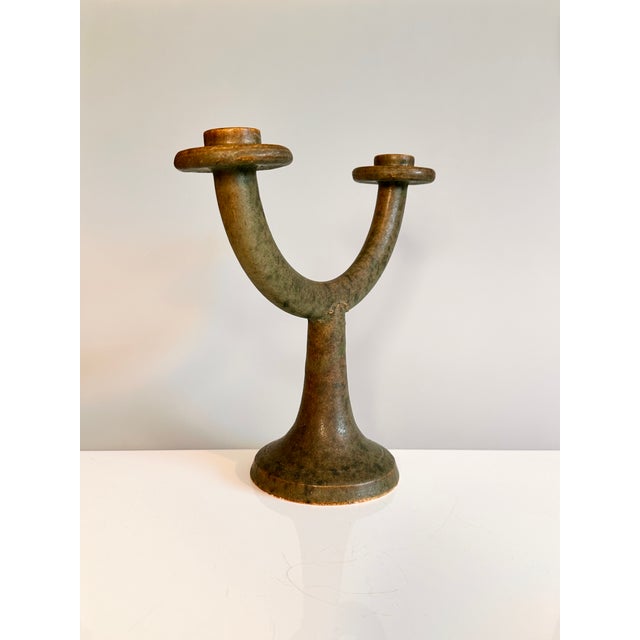 An exceptional studio-ceramic candlestick from the 1960s, in a rare sculptural form. This decorative double candlestick...