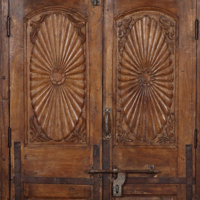 Constructed from antique Indian teakwood doors and architectural elements, this armoire celebrates the craftsmanship of...