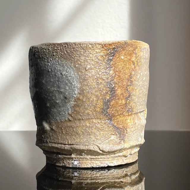 Jeff Shapiro Yunomi Cup (ca.1990). Signed on side of the cup. Organic oval shaped footed yunomi. Light grey stoneware with...