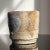 Jeff Shapiro Yunomi Cup (ca.1990). Signed on side of the cup. Organic oval shaped footed yunomi. Light grey stoneware with...