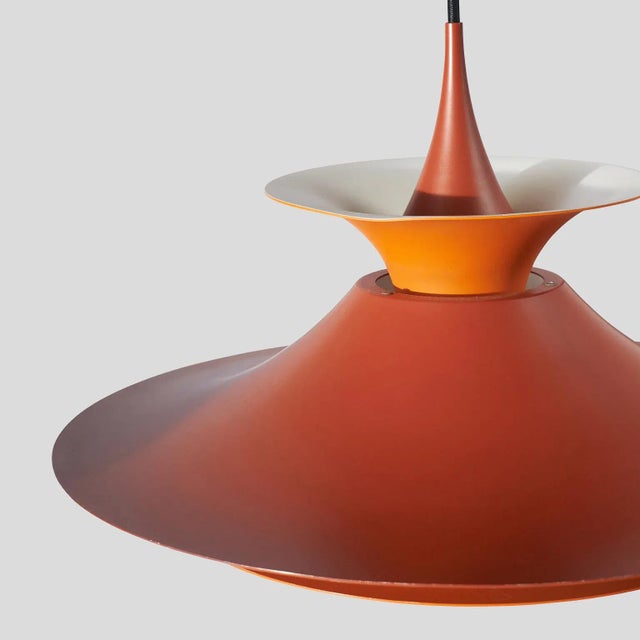 A pendant lamp designed by Eric Balslev and produced by Fog & Mørup in Denmark, c. 1970, made of enameled aluminum Painted...